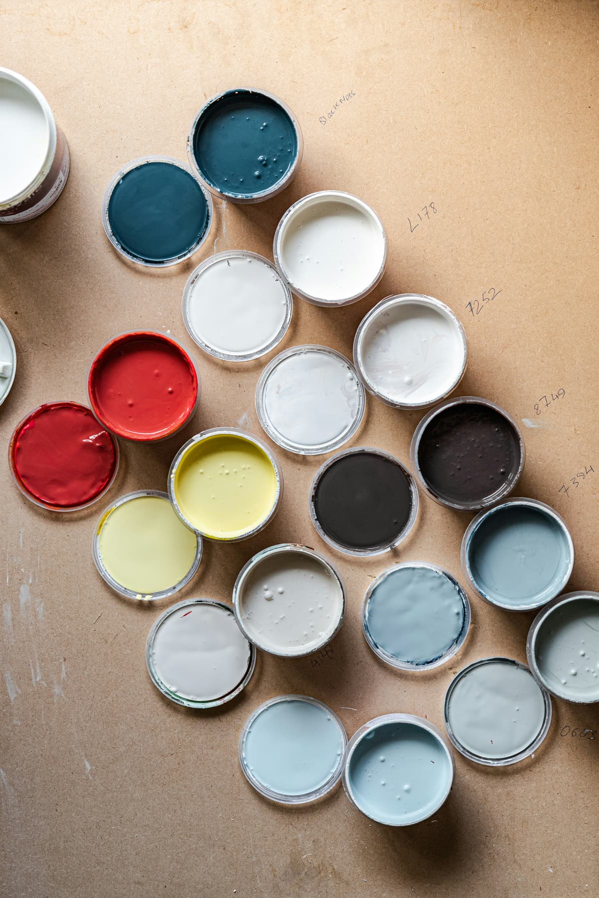 Open paint tins in heritage colours ready for wood painting